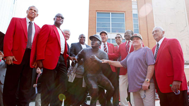 Members of the Reds Great Eight, Cesar Geronimo, left, George Foster, Reds CEO Bob Castellini, Ken Griffey, Sr., Johnny Bench, Tony Perez, Joe Morgan, Pete Rose and David Concepcion at the unveiling of the Joe Morgan statue in Cincinnati.